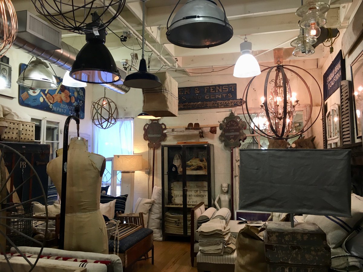 An antique showroom with vintage furniture and light fixtures.