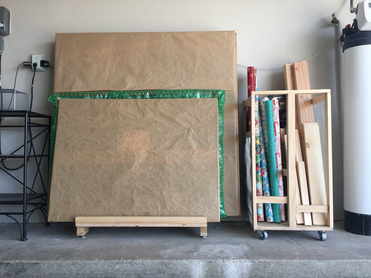 Wrapped canvases on a wood riser, wrapping paper and wood scrap storage