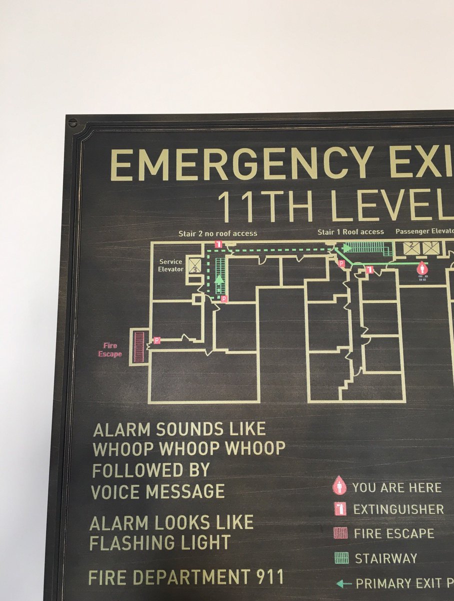 Emergency plan wall plaque that says “Alarm sounds like whoop whoop whoop”