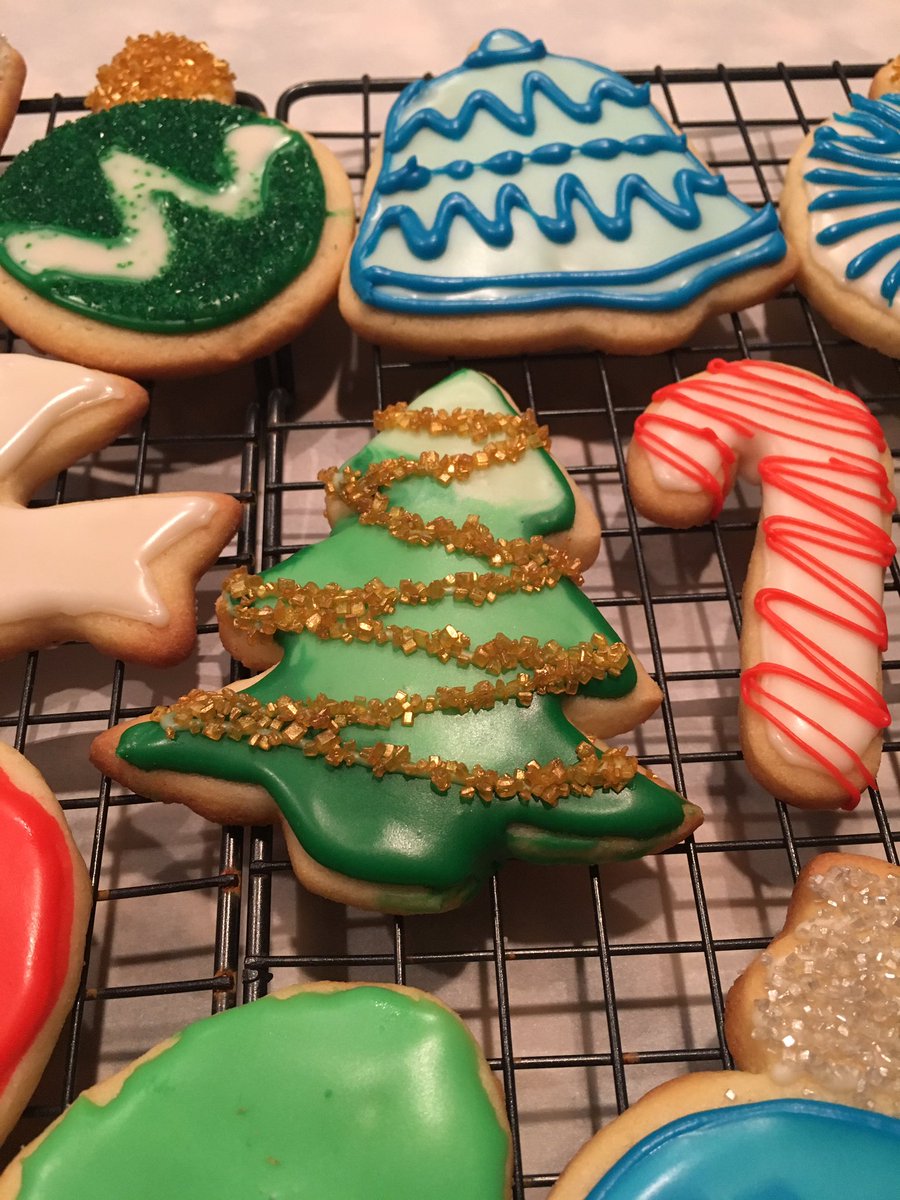 A Christmas tree cookie with gradient green icing