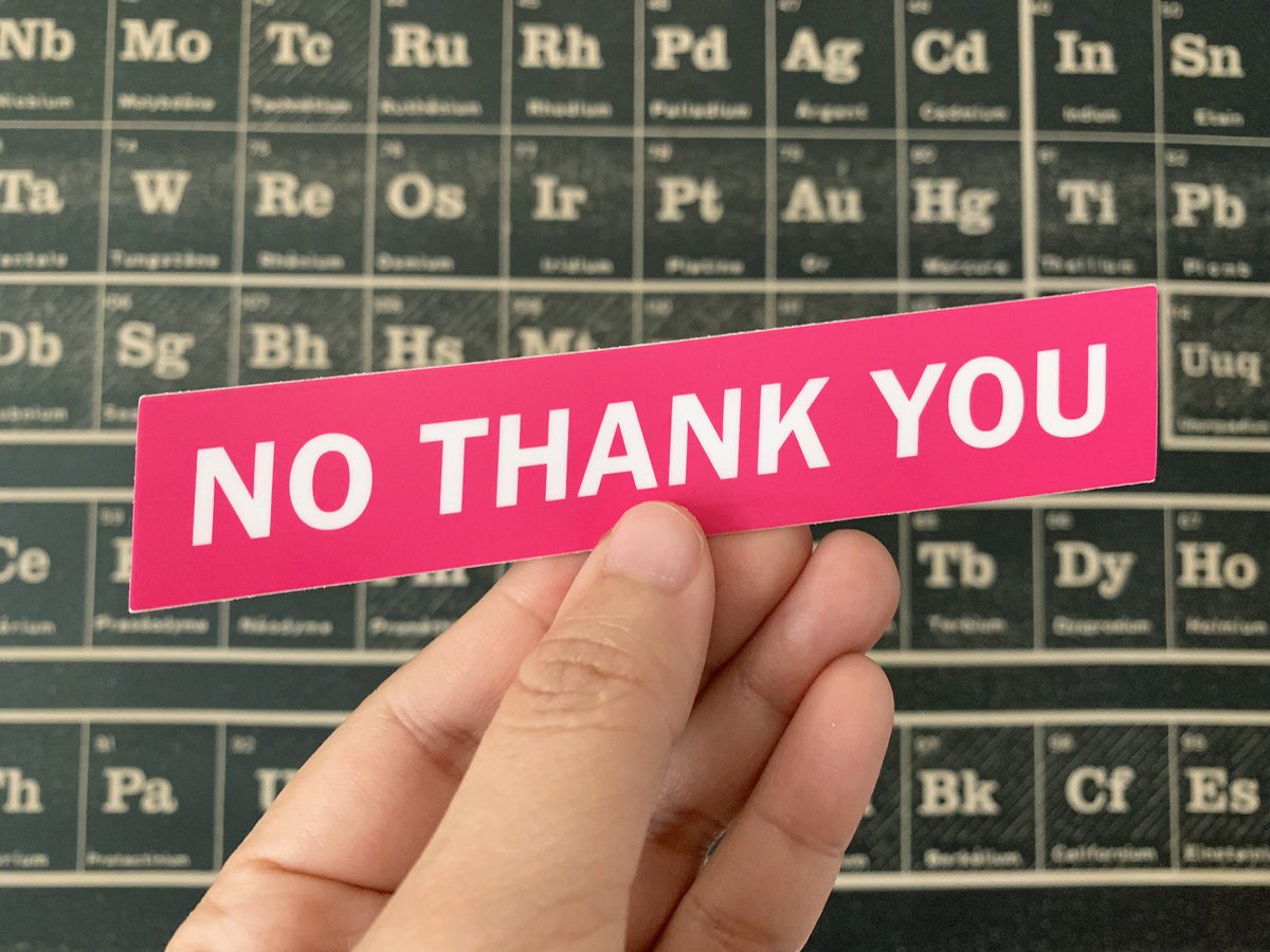 A hand holding a 5" vinyl sticker that says “No thank you” in all caps, white letters on pink background.