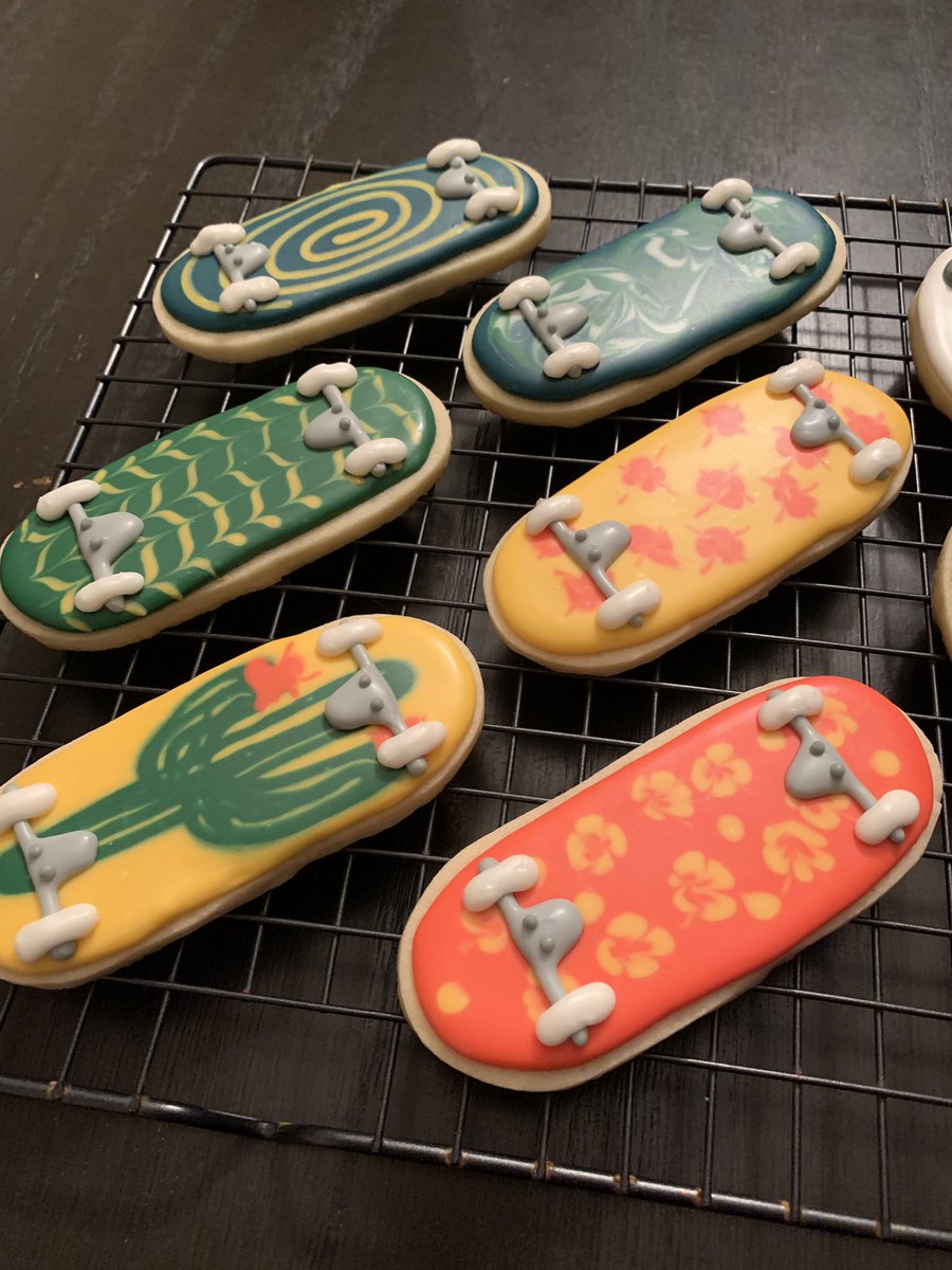 Closeup of sugar cookies decorated like skateboards with patterned decks.