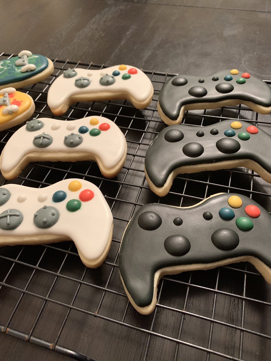 Closeup of sugar cookies decorated like xbox controllers.