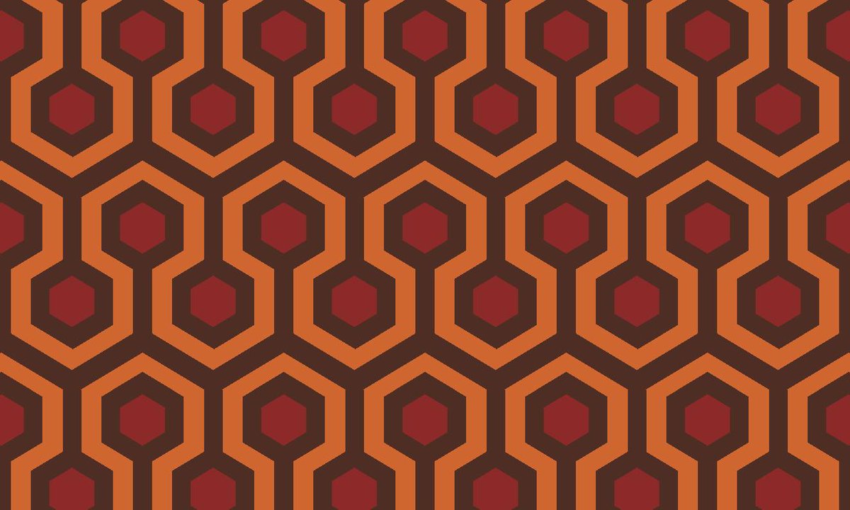 A brown, orange, and red repeating pattern of lines and hexagons.