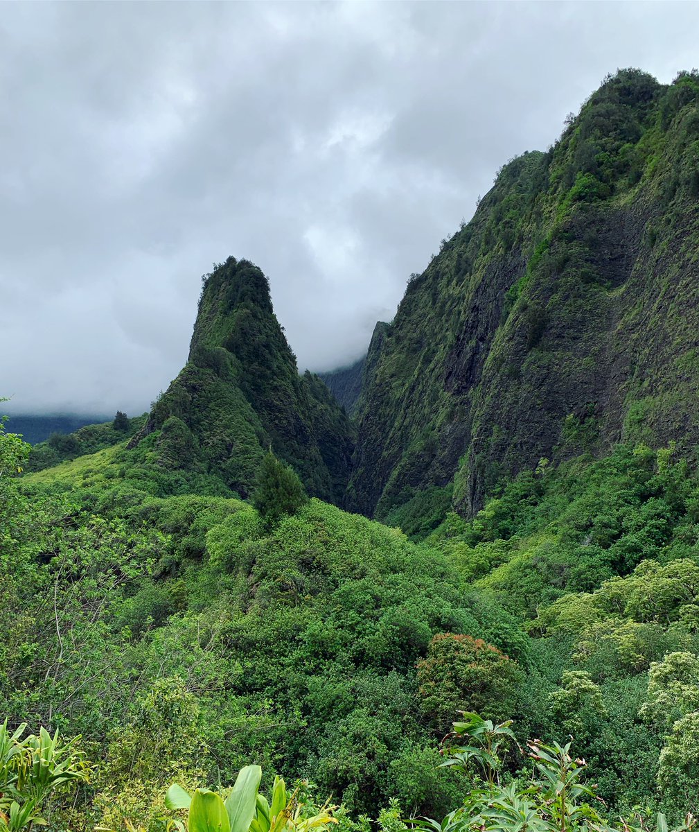 Lush green mountains against a cloudy sky.