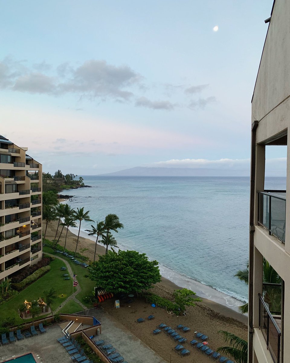 Early morning view from a tall balcony of the beach and ocean.