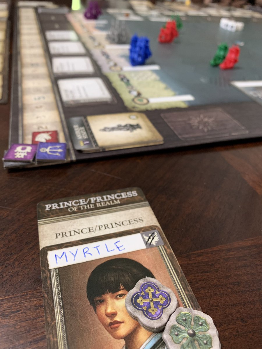 A player card named Myrtle in front of a tabletop game with tiny boats.