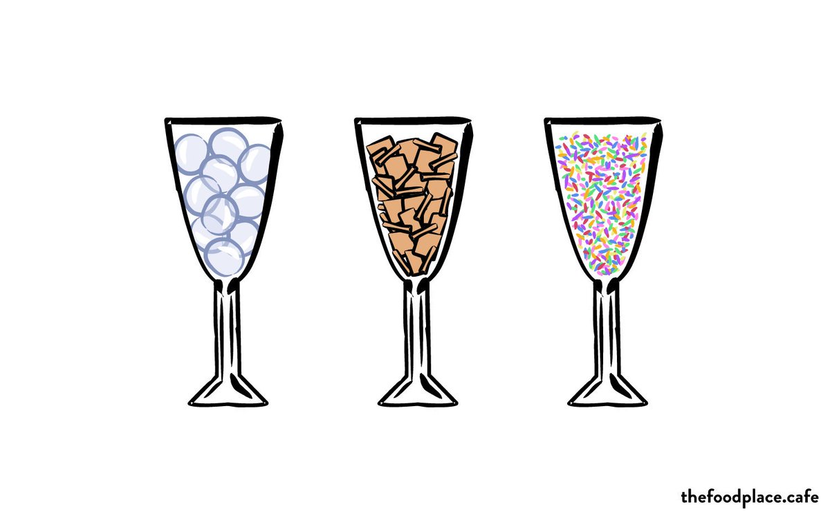 Three champagne flutes filled with bubbles, Scrabble tiles, and rainbow sprinkles.