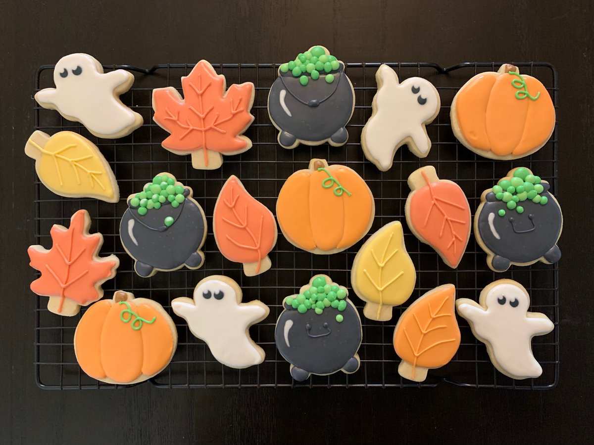 Decorated sugar cookies of pumpkins, fall leaves, ghosts, and bubbly cauldrons.