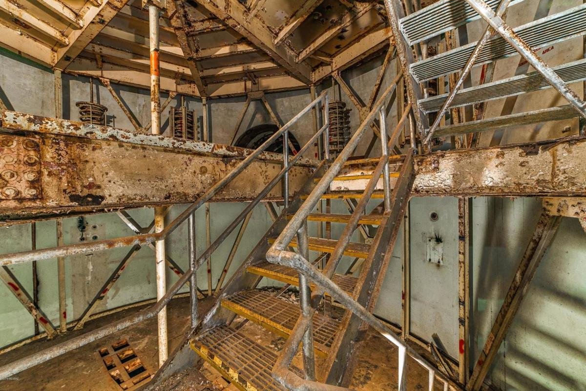 Inside the silo, rusty underground stairwell.