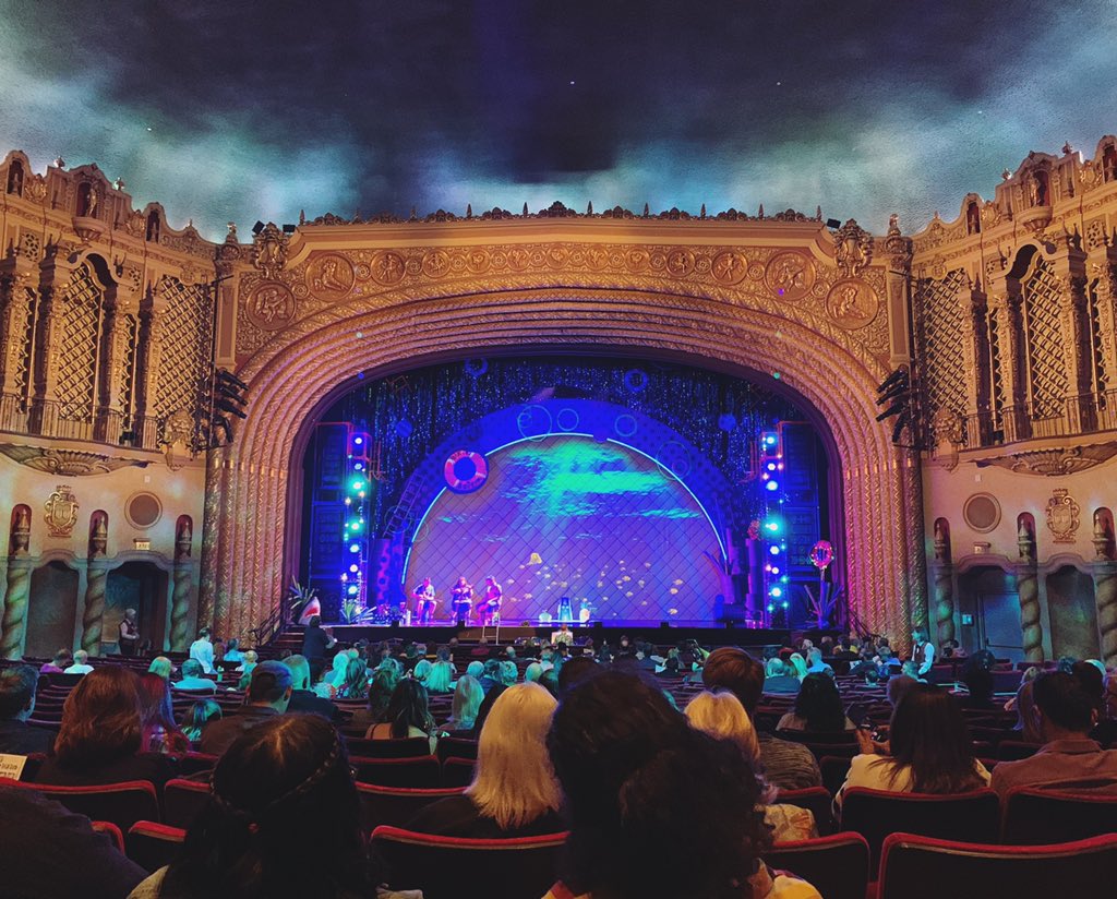 Interior of the Orpheum theatre, intricate architecture, a fake sky, and a bright stage.