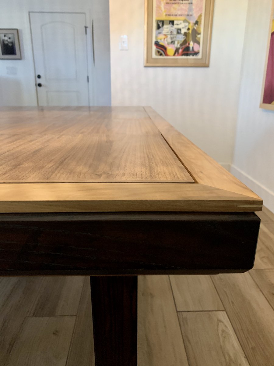 A closeup of the woodwork on the edge of the table. 