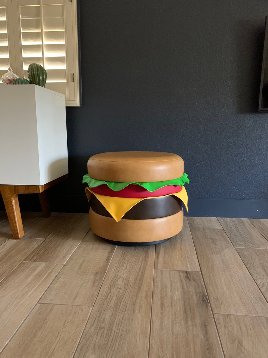 A tailored leather ottoman that looks like a cheeseburger.