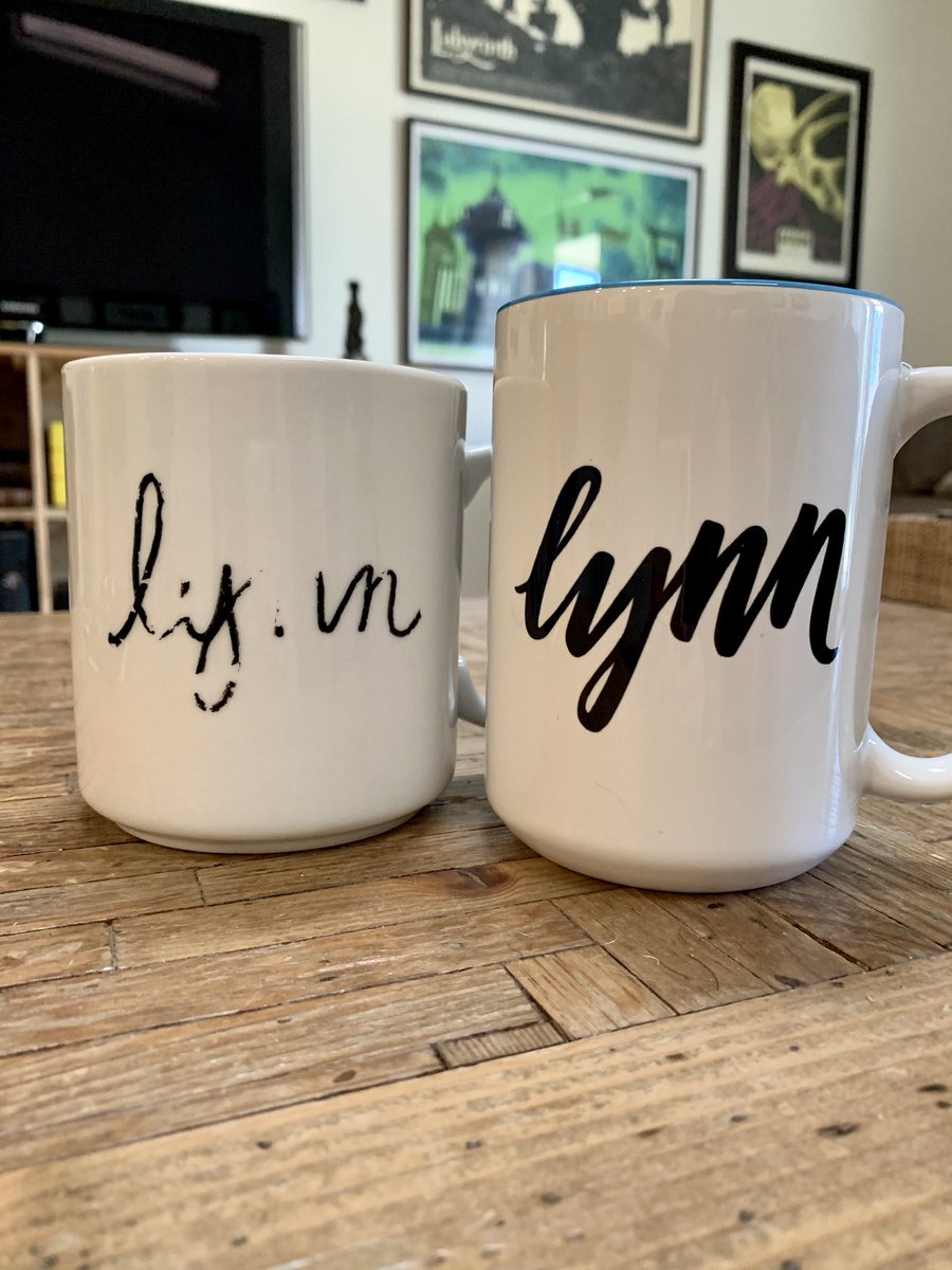 The same two mugs flipped with “Lynn” written in cursive, the first also worn away from use.