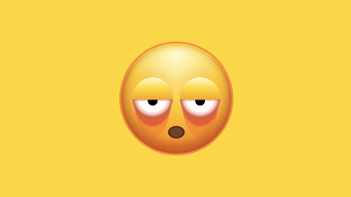 a yellow emoji face with mouth open and exhausted half-closed, red eyes with deep bags underneath