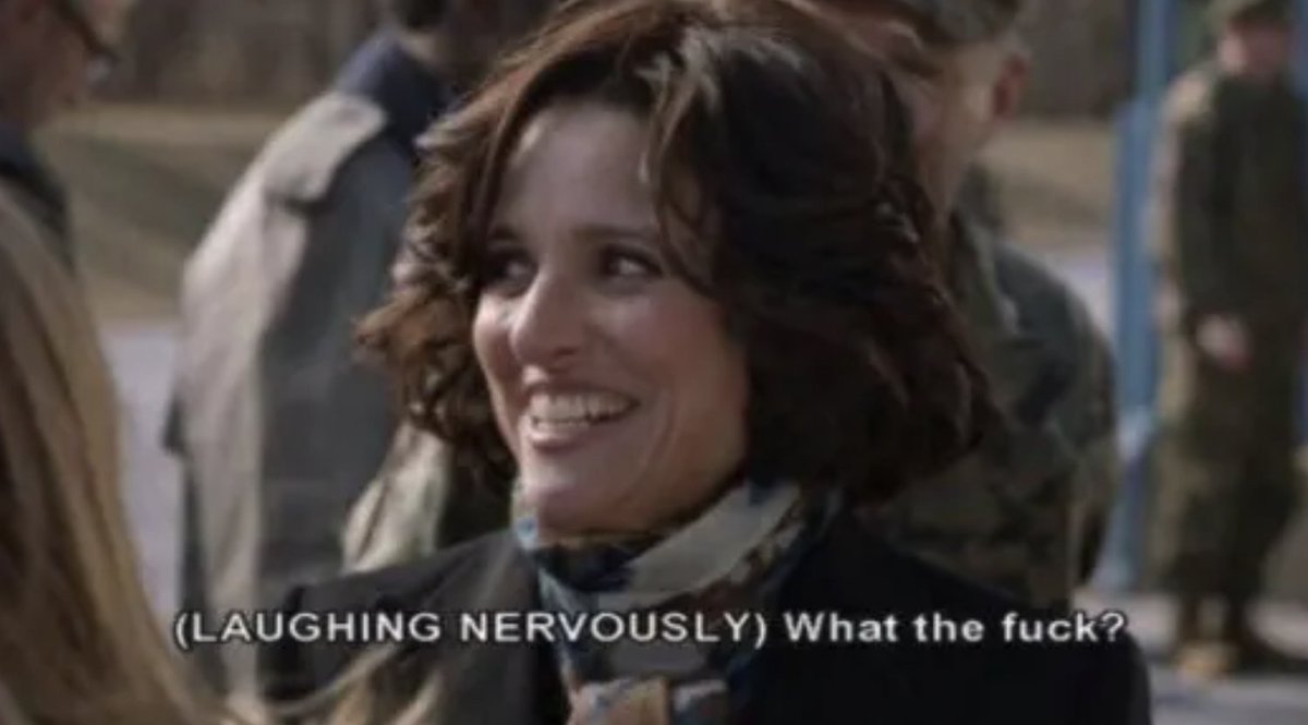 Julia Louis Dreyfus from Veep laughing nervously saying “What the fuck?” under a forced smile