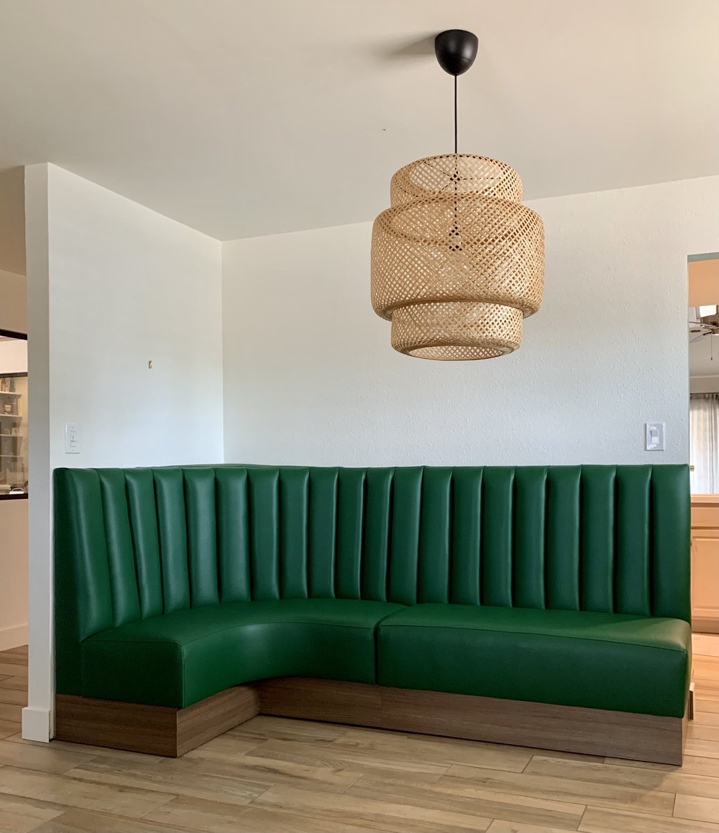 dining nook with a green vertical channel vinyl L-shaped restaurant booth with wood base