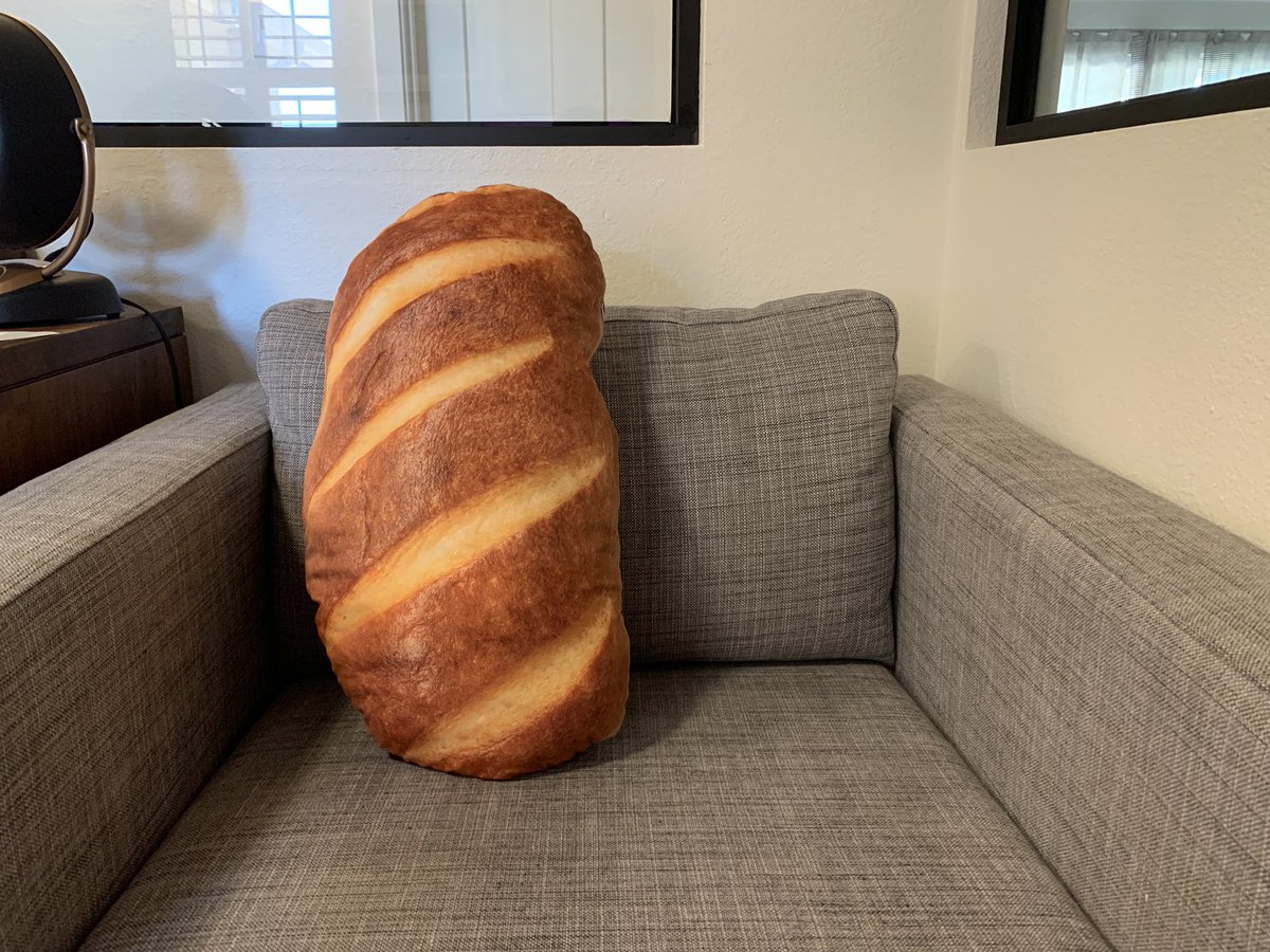 an armchair with a big pillow that looks just like a loaf of bread