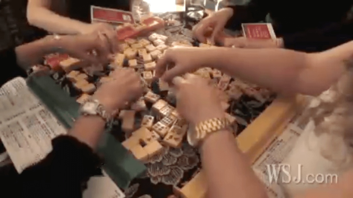 hands playing mah-jongg