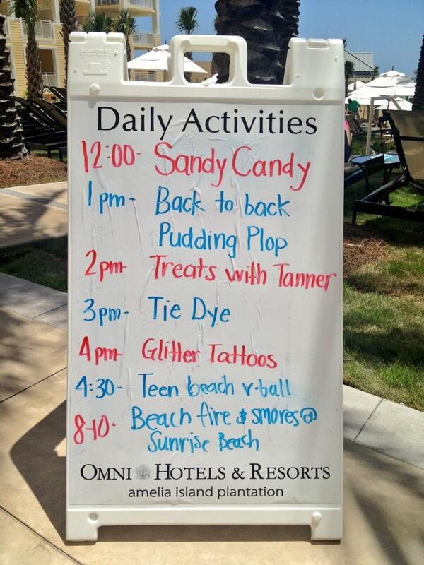 a sandwich board of daily kid activities with Glitter Tattoos at 4pm