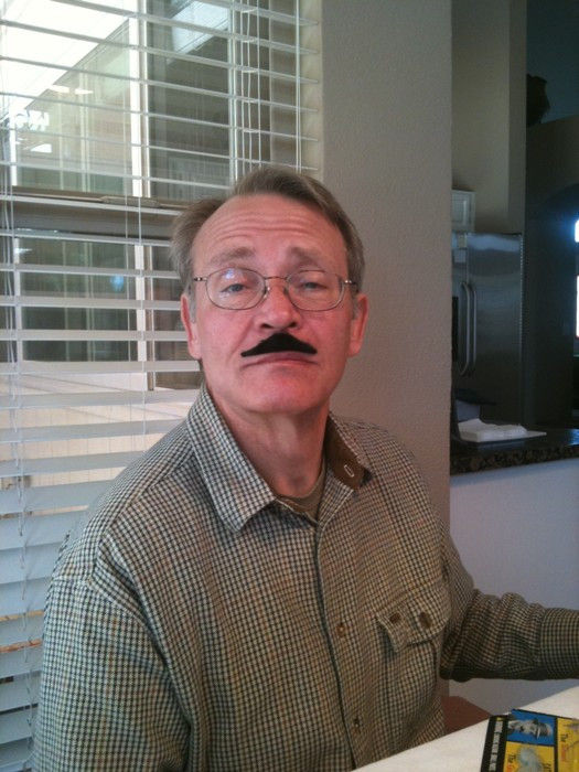 man wearing fake moustache