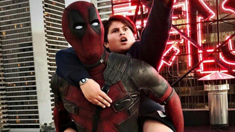 Julian Dennison rides Deadpool's back like Yoda.