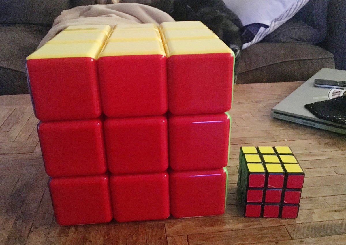 A giant Rubik's cube next to a regular-sized Rubik's cube