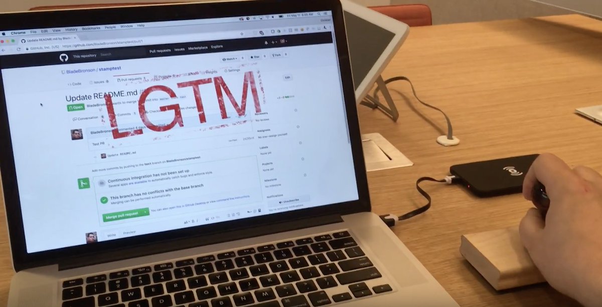 Screenshot of a YouTube video: person using a rubber stamp to add "LGTM" comment to a pull request on their computer in GitHub.