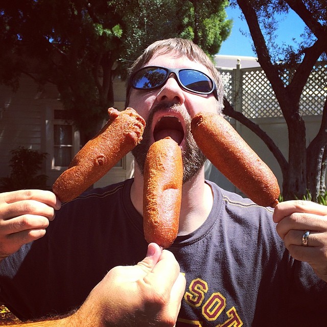 Clay with three big corn dogs in his face