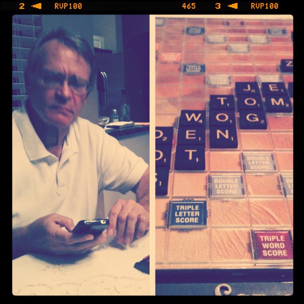 dad on his phone and a scrabble board