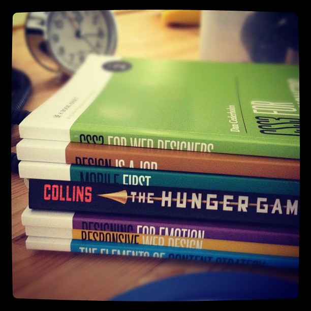 a stack of A Book Apart books with The Hunger Games in the middle