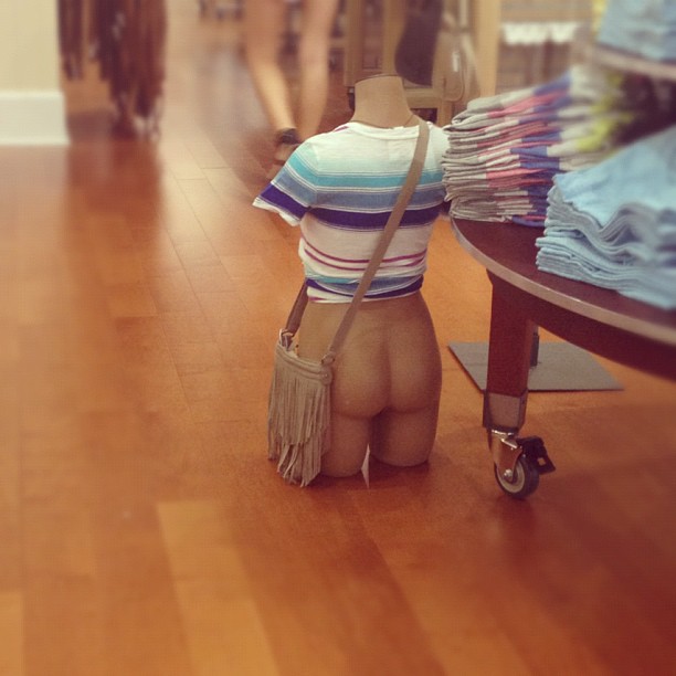 mannequin torso on the ground wearing a shirt but no pants