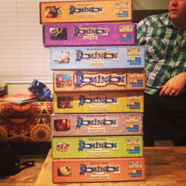 stack of 8 expansion games for Dominion