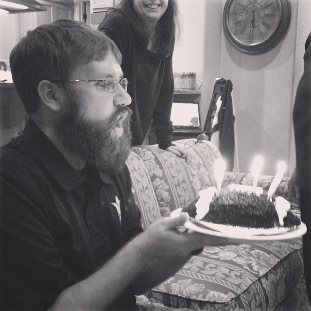 Clay blowing out the candles on a football cake