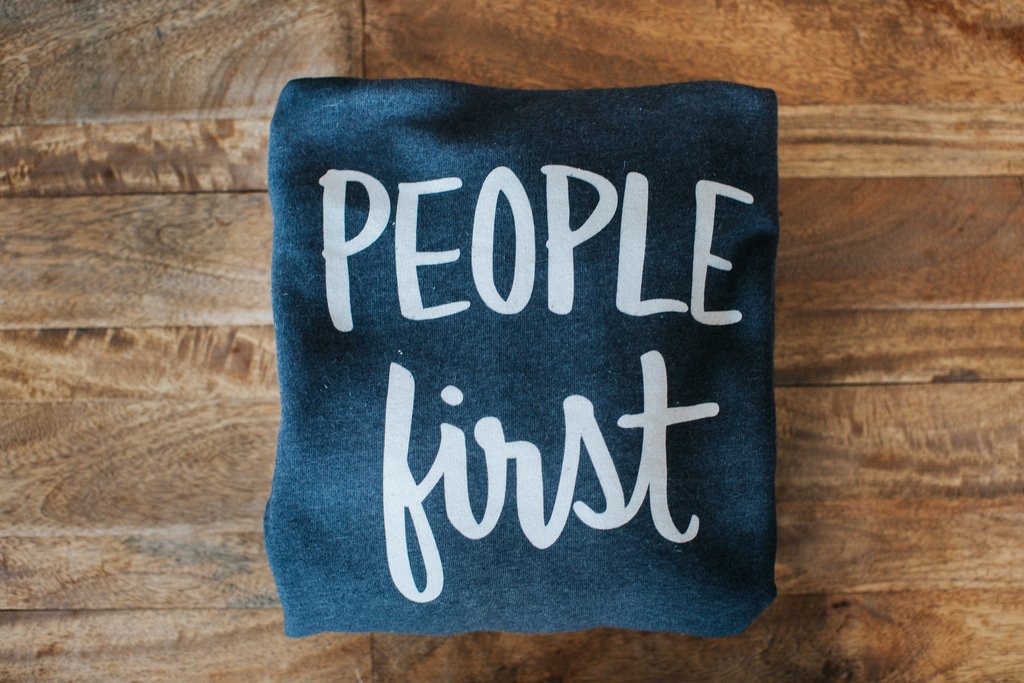 hoodie with hand-lettering “People first”