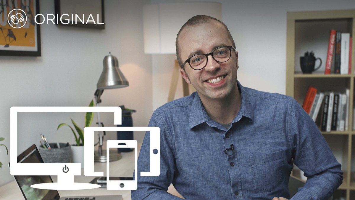 Ethan Marcotte sitting at a desk, next to a laptop, a smartphone, and a tablet